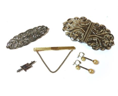 A silver belt buckle marked Sheffield 1982, makers mark M.T., a silver marcasite set brooch, an American flag bar brooch, a b