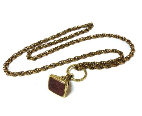 A case gold seal set with a carved intaglio cornelian, with gold chased split ring (tested as 18ct gold) on a gilt metal doub