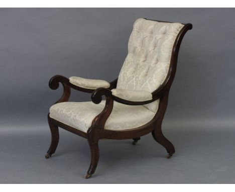 A Victorian mahogany open armchair with button upholstered back, sabre legs, and ceramic casters