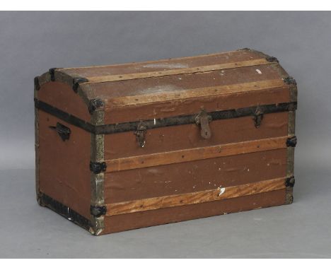 An early 20th century dome topped wooden board travelling trunk, fitted pair of wrought iron handles, 82cm wide, 48cm deep an