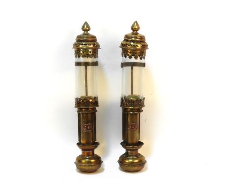 A pair of GER brass railing lanterns with cylindrical glass shades and pierced detail each with copper GER labels, height 36c