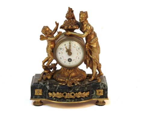 A late 19th century French gilt metal and marble mantel clock, the white enamel dial with floral basket surmount, flanked by 