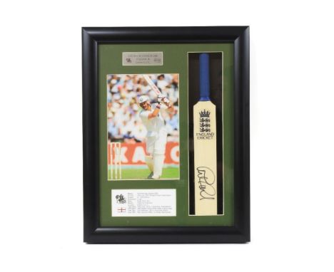 A signed Graham Gooch miniature bat, in a glazed case