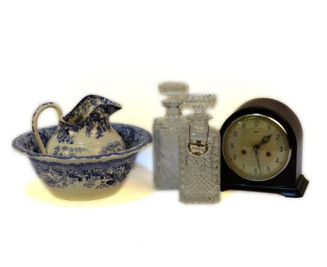 A 20th century Smiths Bakelite mantel clock, a blue and white porcelain toilet jug and bowl, and two whisky decanters