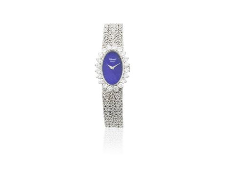 Chopard. A recently serviced lady's 18K white gold and diamond set manual wind oval bracelet watch with lapis lazuli dialRefe