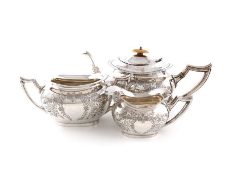 λA three-piece Edwardian silver tea set, by J. Gloster Ltd, Birmingham 1908, oblong bellied form, engraved foliate decoration