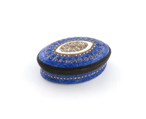A late 18th / early 19th century enamel patch box, oval form, with gilt highlights on a blue ground, the interior of the hing