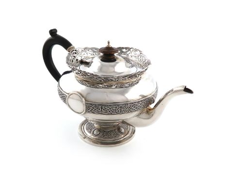 An Irish silver teapot, by Sharman D Neill, (of Belfast), Dublin 1910, circular bellied form, with Celtic strap-work decorati