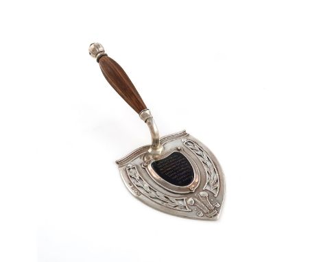 By Nelson Dawson, an Edwardian Arts and Crafts silver presentation trowel, London 1901, the shaped triangular blade with pier