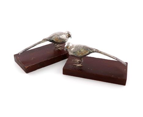 A pair of metalware and enamel models of birds, unmarked, modelled in standing positions, with enamelled feathers and feature