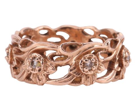 Stuart Devlin - a diamond-set 'Daffodil' ring in 14ct rose gold, with a pierced repeating pattern of seven stylised daffodil 