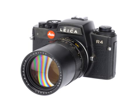 A Leica R4 SLR Camera, black, serial no. 1561911, with Leitz Elmarit-R f/2.8 135mm lens, black, serial no. 3105857, body, G, 