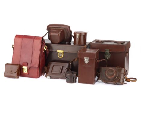 A Leica CL Camera Outfit Case and Other Camera Cases comprising a red Leica CL outfit case made by Minolta, a brown leather m