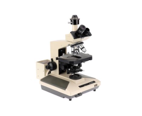 An Olympus BH-2 Trinocular Microscope Japan, c.1990, labeled to the front OLYMPUS BH-2, the microscope with a halogen lamp to