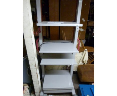 An adjustable height shelf unit on wheels