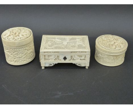 A very finely carved and pierced ivory casket c1900, together with two carved circular lidded pots of a similar age, the cask