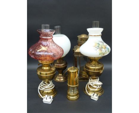 Five brass oil and other lamps, including a miner's lamp