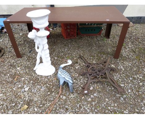 A metal heron, jardiniere and a pair of bench ends