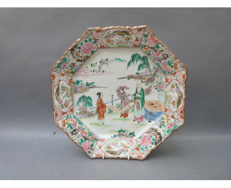 A Chinese octagonal charger decorated with three figures holding a scroll painting, birds to the border and gilt rim, 32cm in
