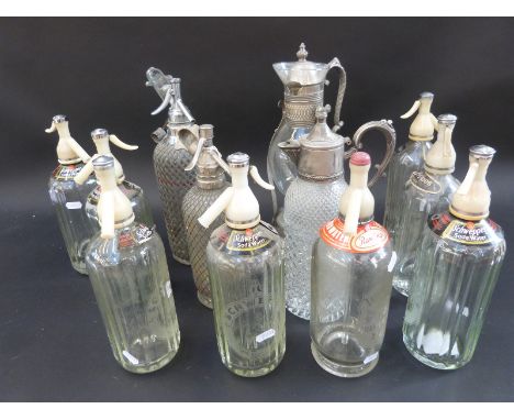 Twelve vintage soda siphons, plated claret jug etc 