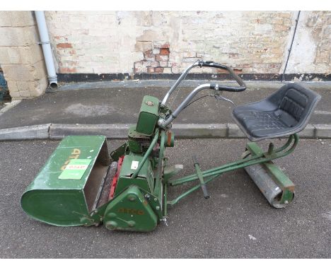 An Atco sit on petrol mower with manual