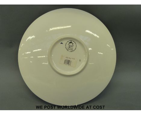 A retro Poole charger bowl with dolphin decoration, with certificate of authenticity (40cm diameter)