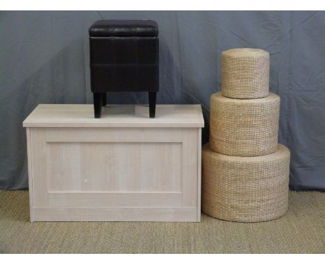 A modern trunk, leather seat and wicker tables