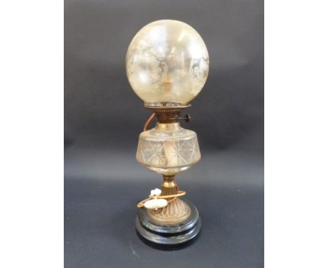 A brass and glass oil lamp with cut bowl and engraved shade, converted to electricity, 55cm tall