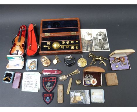 A cased Sikes hydrometer, miniature violin, military Leonidas pocket watch, fobs, penknives, speedway tickets, silver teaspoo