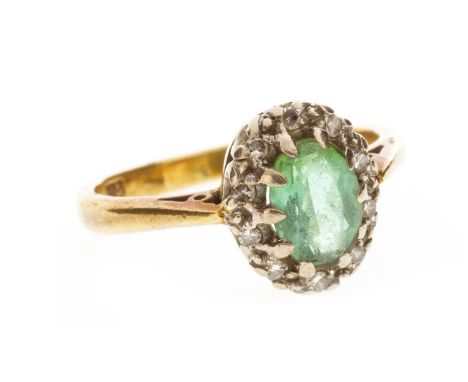 DIAMOND AND GREEN GEM SET RING, set with a faceted oval green gem surrounded by round diamonds, in eighteen carat gold, size 