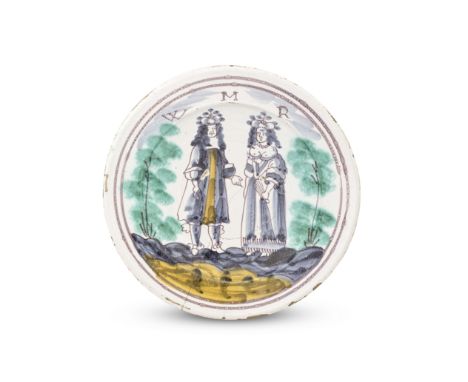 An English delftware royal charger, circa 1689-94Probably London, painted in manganese outline and coloured in dark blue and 