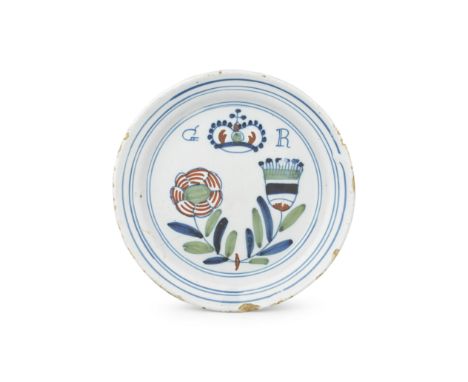 A Vauxhall delftware 'Union' plate, circa 1715Painted in blue, green and red with a rose and thistle, tied by a red ribbon sy