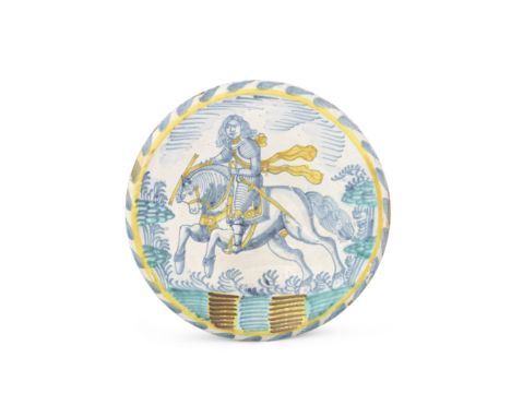 An exceptional English delftware equestrian charger, circa 1680-90Painted in blue, ochre and turquoise with a mounted soldier