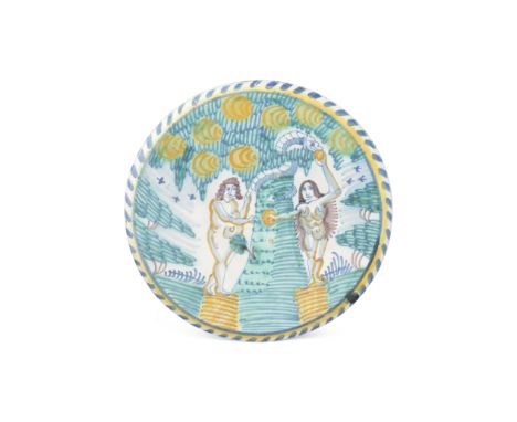 A striking English delftware Adam and Eve charger, circa 1670-85Probably London, painted in blue, green, manganese and ochre,