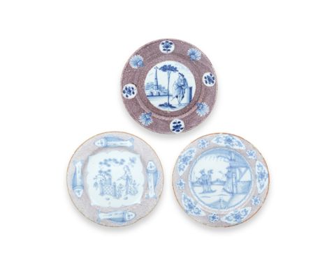 Three English delftware plates, circa 1740-60Painted in blue with panels reserved on a powder manganese ground, one with eigh