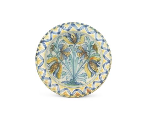 A rare English delftware charger bowl, circa 1660-70Probably Southwark, the deep circular centre within a flanged rim, painte