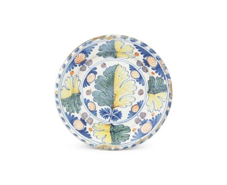 An English delftware Oak Leaf and Fruit charger, late 17th centuryPainted in a pleasing palette of blue, mottled green, ochre
