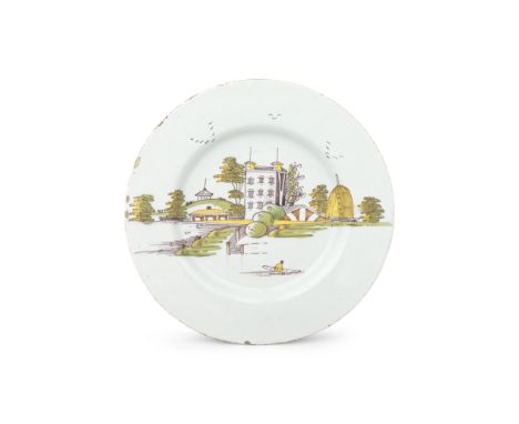 A Liverpool delftware plate, circa 1750-60Painted in an attractive polychrome palette in 'Drinkwater' style with a grand hous