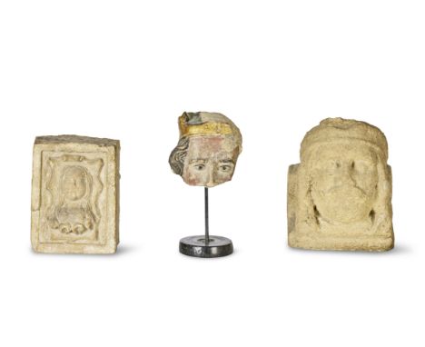 A carved limestone mask fragment of a head of a king, possibly Saint EdmundProbably Medieval, 15th century With traces of ori