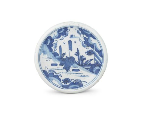 An English delftware small charger, late 17th centuryLondon or possibly Brislington, painted in blue with a Chinese figure ho