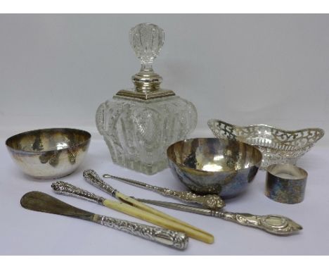 A silver rimmed decanter, a/f, three plated dishes and four silver handled tools