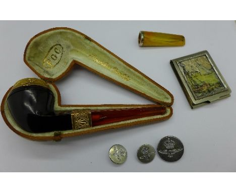 A cased pipe with rolled gold decoration, an amber and silver cheroot holder, three RAF buttons and a matchbook holder