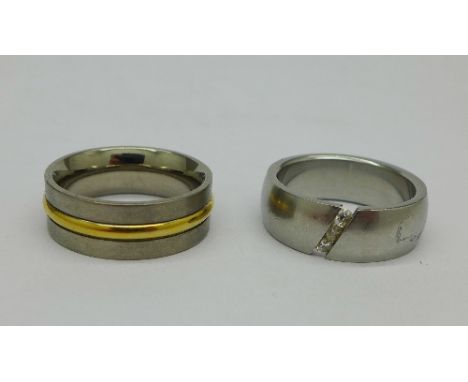 A titanium ring set with white stones and one other titanium ring, U and S