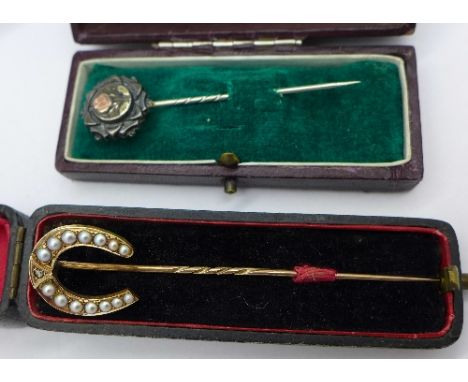 A stick pin set with pearls and a diamond and one other stick pin