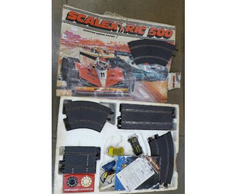 A Scalextric electric model racing with Mini and Ford Escort cars
