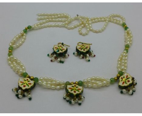 An Indian, yellow metal, pearl and enamel necklace and earrings set