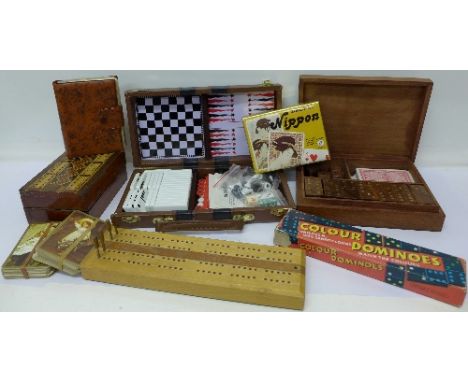 Assorted board games including dominoes, cribbage, cards and accessories