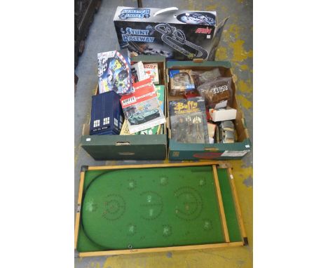 Two boxes of mixed collectables including die-cast, bagatelle and a boxed Artin "Stunt Raceway".