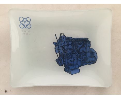 A Perkins Diesel opaque glass trinket dish with pictorial design depicting an engine. 