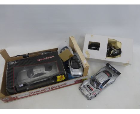 An assortment of die-cast models including a special edition Maisto Mercedes CLK-GTR Street Version and a Franklin Mint Harle